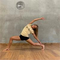 Yana in a studio, stretching.