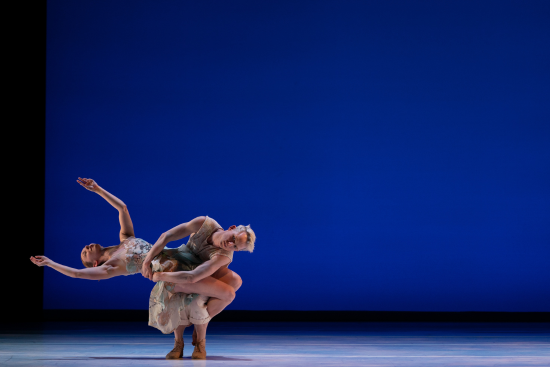 Two Dancers on a stage with a blue background